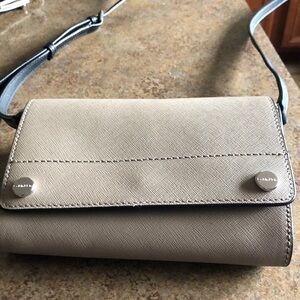 Beige/nude CK shoulder bag with black strap. Ideal for a night out!